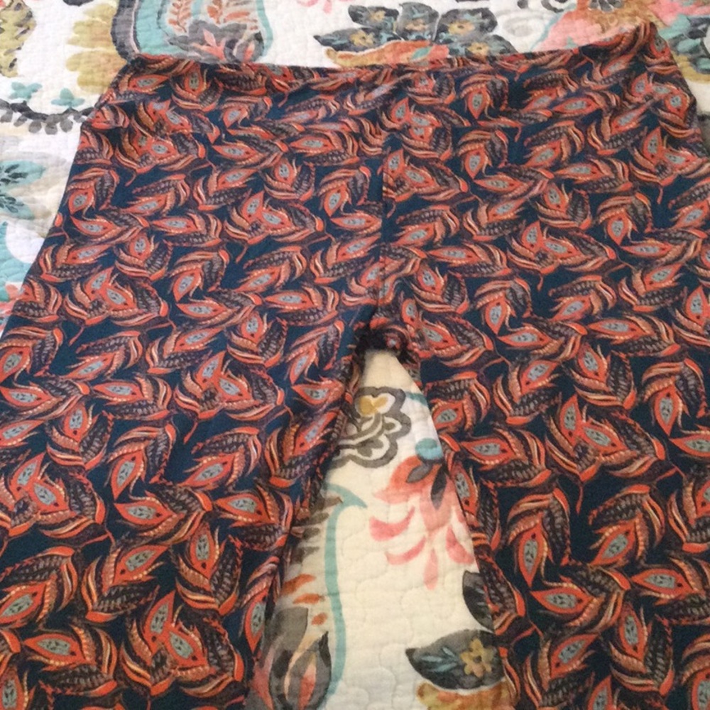 Brand new Lularoe Leggings, Size TC. Blue with feather pattern in burnt orange